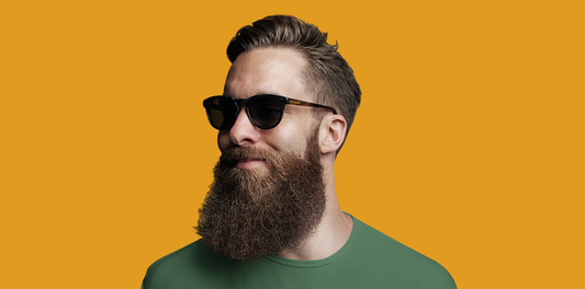 Hairy As Beard Love young man with a full beard showing the benefits of daily beard oil use. Orange background.