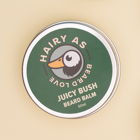 Hairy As Beard Love Beard Balm blend Juicy Bush. A 60ml grey aluminium screw top tin. Label is green with cream coloured font. Features the Hairy As logo of a bearded duck.